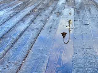 abstract reflective rain puddle on wood