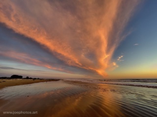 pink and orange sunset along the beach