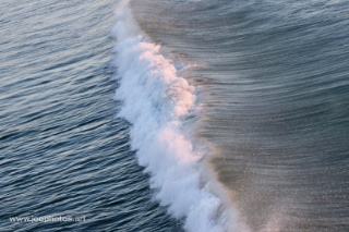 crashing sculpted ocean waves at sunrise