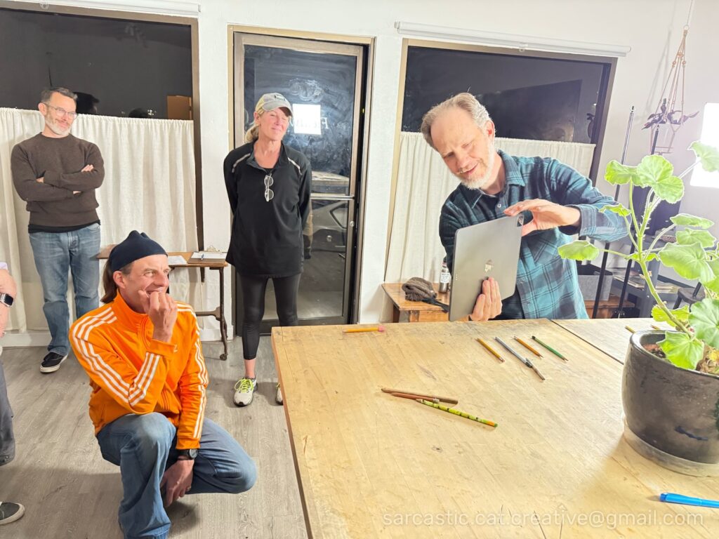 Joe demonstrates zooming in on a subject while other students observe.